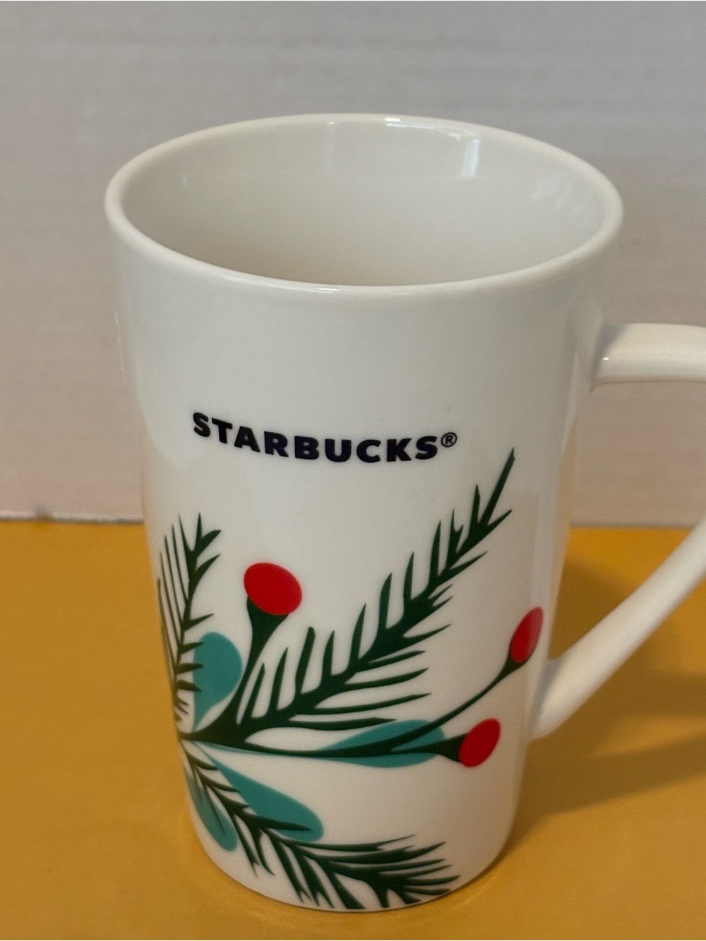 Starbucks White Ceramic Mug with Green Pine Sprigs and Red Berry Details